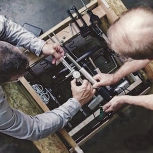 Workers calibrating recliner mechanism