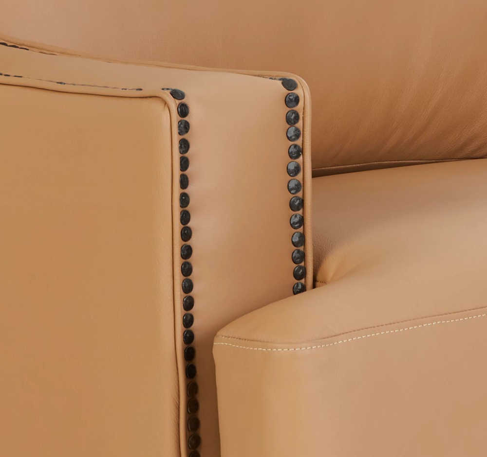 Closeup of nailhead trim on the arm of a Makenna duo® Reclining Sofa