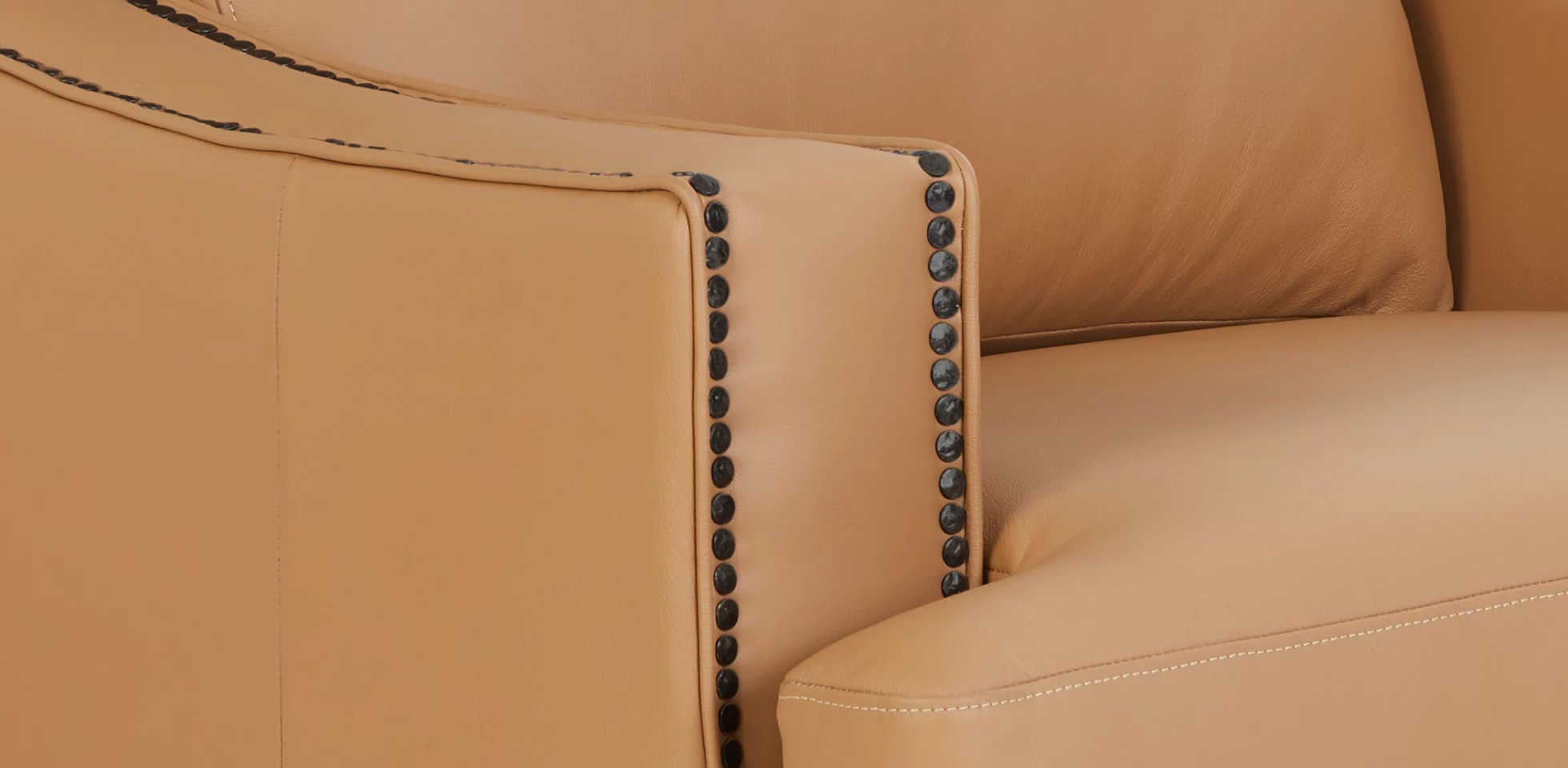 Closeup of nailhead trim on the arm of a Makenna duo® Reclining Sofa