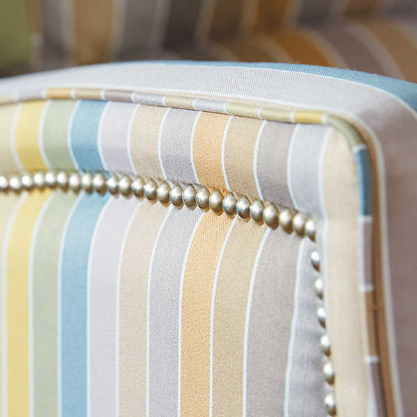 Closeup of platinum nailhead trim